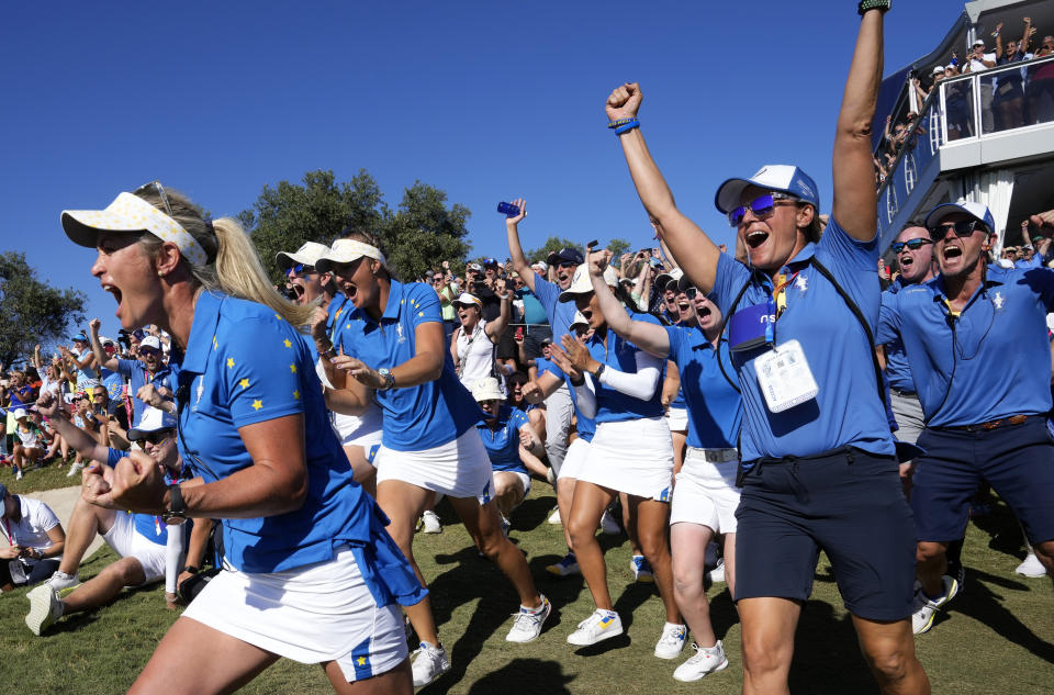 Members of the Europe team and supporters celebrate at the end of the match between Europe's Carlota Ciganda and United States' Nelly Korda at the Solheim Cup golf tournament in Finca Cortesin, near Casares, southern Spain, Sunday, Sept. 24, 2023. Europe play the United States in this biannual women's golf tournament, which played alternately in Europe and the United States. (AP Photo/Bernat Armangue)