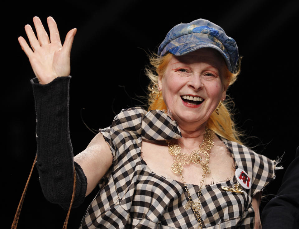 FILE - British fashion designer Vivienne Westwood waves to the audience after presenting the Vivienne Westwood fashion collection from the men's Spring/Summer 2013 collection, part of the Milan Fashion Week, unveiled in Milan, June 24, 2012. Westwood, an influential fashion maverick who played a key role in the punk movement, died Thursday, Dec. 29, 2022, at 81. (AP Photo/Luca Bruno, File)