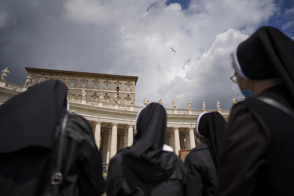 Nuns watch Pope Francis as he recites the Regina Caeli noon prayer from the window of his studio overlooking St.Peter's Square, at the Vatican, Sunday, April 18, 2021. Pope Francis said he is happy to be back greeting the faithful in St. Peter’s Square faithful for his traditional Sunday noon blessing after weeks of lockdown measures. (AP Photo/Andrew Medichini)