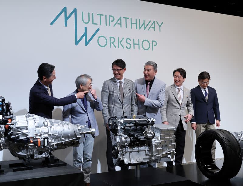 Subaru's CEO Atsushi Osaki, CTO Tetsuo Fujinuki, Toyota's CEO Koji Sato, CTO Hiroki Nakajima, Mazda's CEO Masahiro Moro and CTO Ichiro Hirose chat during a photo session at a press conference, in Tokyo