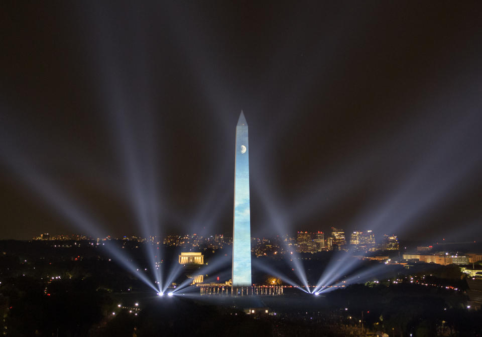 In this photo provided by NASA, the 50th anniversary of the Apollo 11 mission is celebrated in a 17-minute show, "Apollo 50: Go for the Moon" which combined full-motion projection-mapping artwork on the Washington Monument and archival footage to recreate the launch of Apollo 11 and tell the story of the first moon landing, Friday, July 19, 2019, in Washington. (NASA/Bill Ingalls via AP)