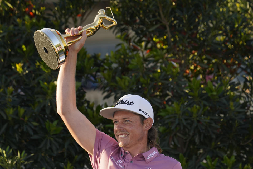 Cameron Smith, of Australia, holds the trophy after winning The Players Championship golf tournament Monday, March 14, 2022, in Ponte Vedra Beach, Fla. (AP Photo/Gerald Herbert)