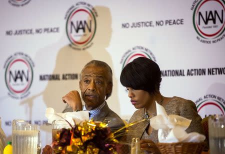 Baltimore mayor Stephanie Rawlings-Blake talks to Rev. Al Sharpton at a church in Baltimore, Maryland April 30, 2015. REUTERS/Eric Thayer