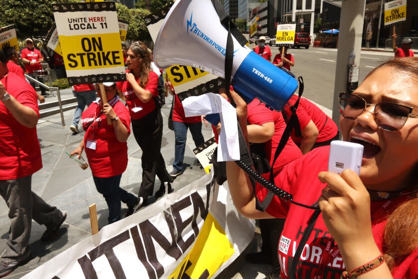 LOS ANGELES, CA - JULY 2, 2023 - Hotel worker Martha Munoz uses the bullhorn while picketing in front of the Intercontinental Hotel as members of Unite Here Local 11 joined dozens of other southland hotels who went on strike today in downtown Los Angeles on July 2, 2023. Hotel workers formed picket lines at many of the businesses in an effort to secure higher pay and improvements in health care and retirement benefits. The contract between the hotels and Unite Here Local 11 expired at 12:01 a.m. on Saturday (Genaro Molina / Los Angeles Times)