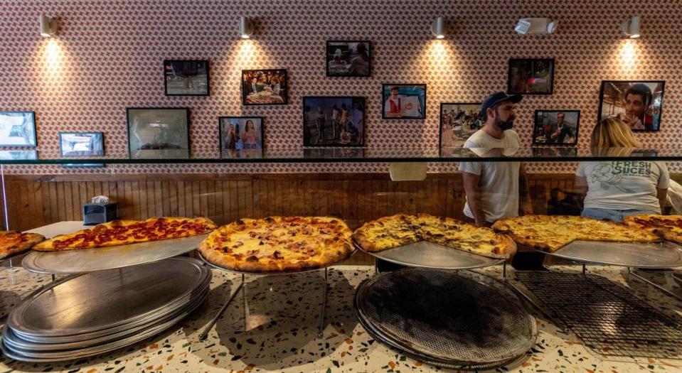 One wall inside Far Out Pizza is devoted to movie scenes in which a character is eating pizza.