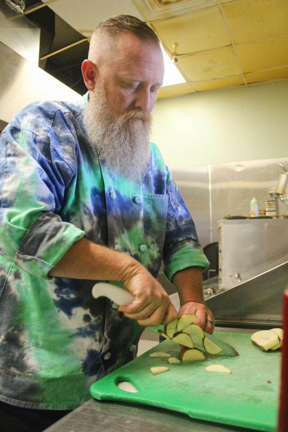 Chef Jason Brewer preps vegetables Wednesday morning at Bar515 Cocktails & Tapas in Pace.