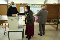A woman casts her vote during the presidential elections in Geroskipou in south west coastal city of Paphos, Cyprus, Sunday, Feb. 5, 2023. Cypriots began voting for their eighth new president in the ethnically divided island’s 62-year history as an independent republic, with three front-runners each portraying themselves as the safest bet to guide the country through turbulent economic times and to seek peace with breakaway Turkish Cypriots. (AP Photo/Petros Karadjias)