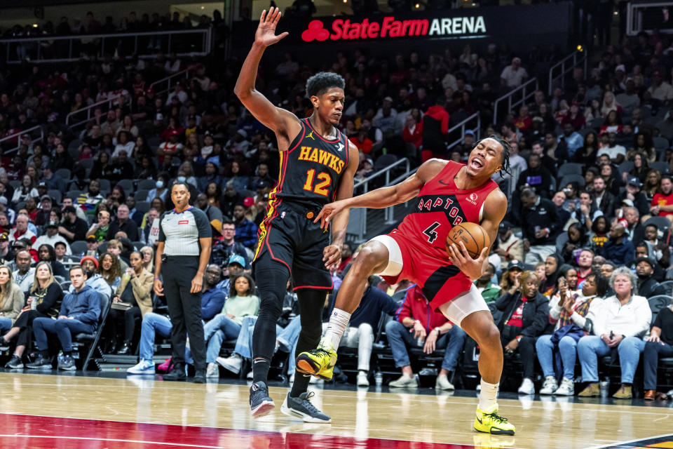 Toronto Raptors forward Scottie Barnes (4) is fouled by Atlanta Hawks forward De'Andre Hunter (12) during the first half of an NBA basketball game, Friday, Feb. 23, 2024, in Atlanta. (AP Photo/Jason Allen)