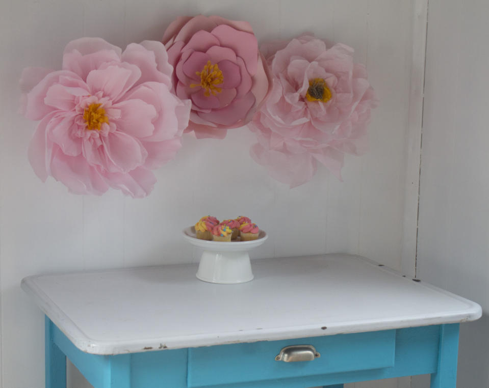 This April 20, 2019 photo shows large paper flowers in Hopkinton, N.H. The flowers can add impact to party decor, whether for a wedding, baby shower or Mother's Day brunch. This grouping features blooms in similar hues made with three different types of paper. (AP Photo/Holly Ramer)