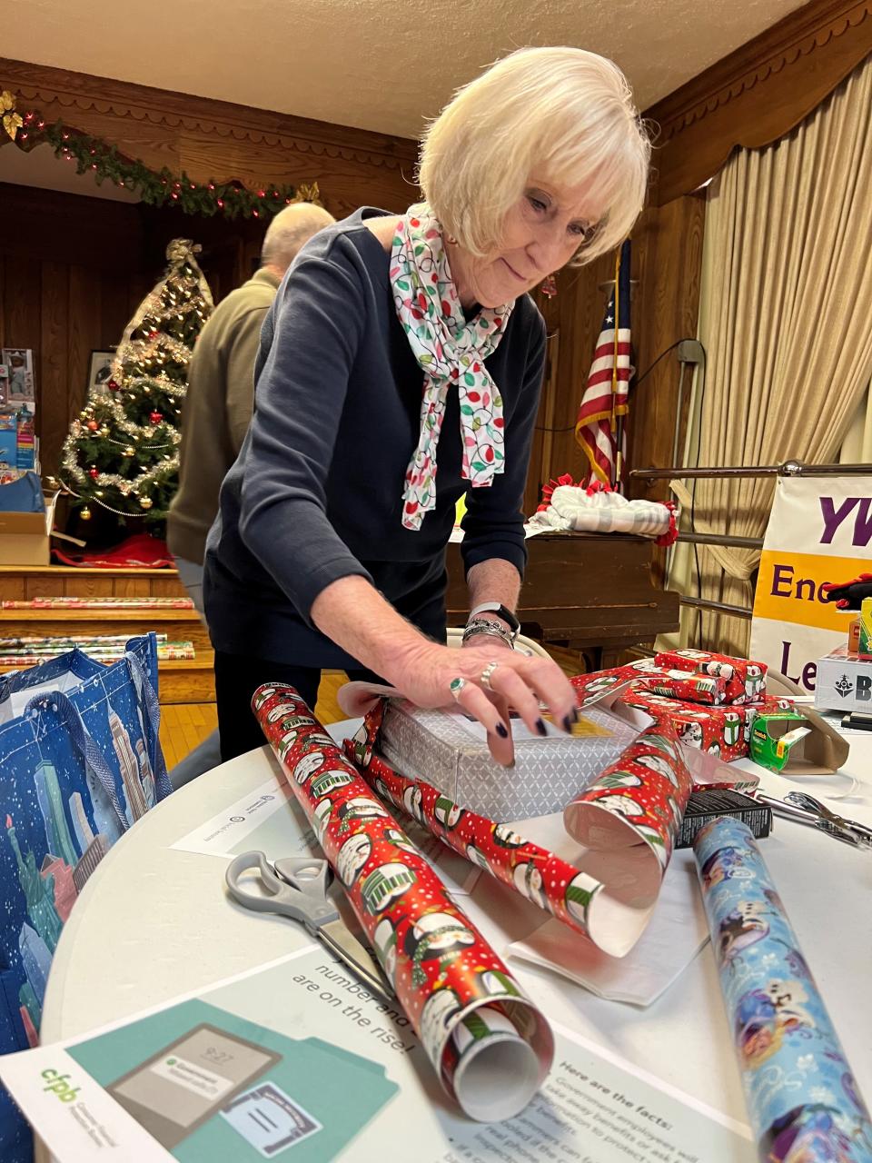 Pat Gates wraps a present at the Alliance YWCA on Thursday, December 2, 2021.