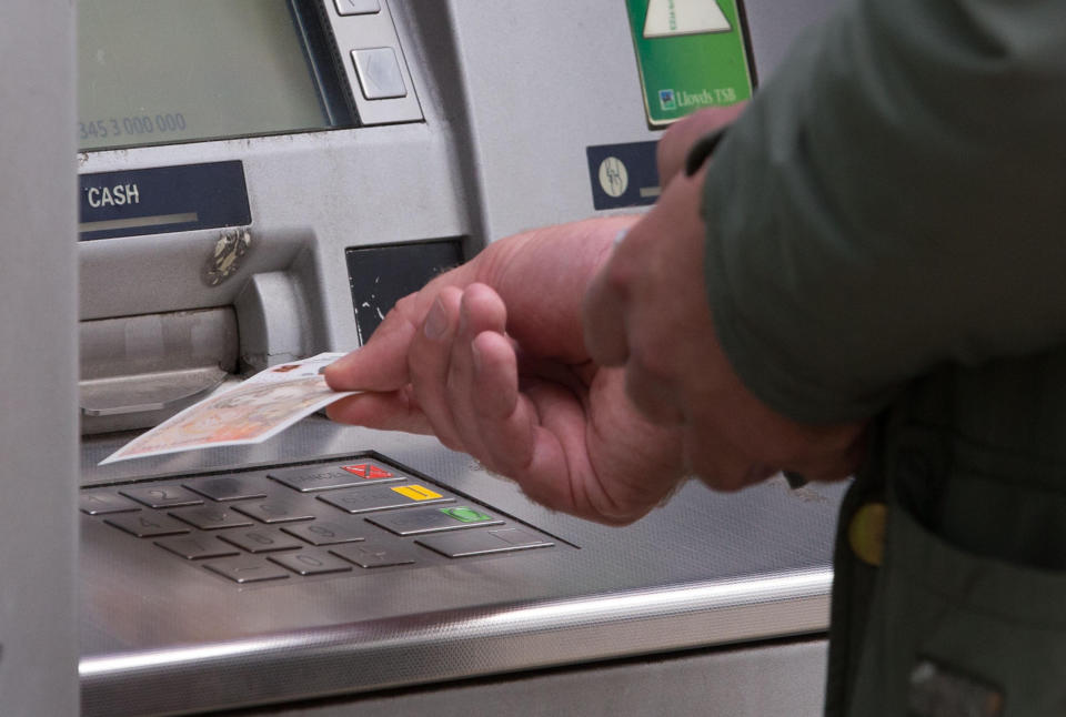 EMBARGOED TO 0001 THURSDAY OCTOBER 29 File photo dated 14/09/17 of a man withdrawing money from an ATM. Consumers have withdrawn nearly �2.5 billion less from Scotland's cash machines during the coronavirus pandemic, according to new figures.