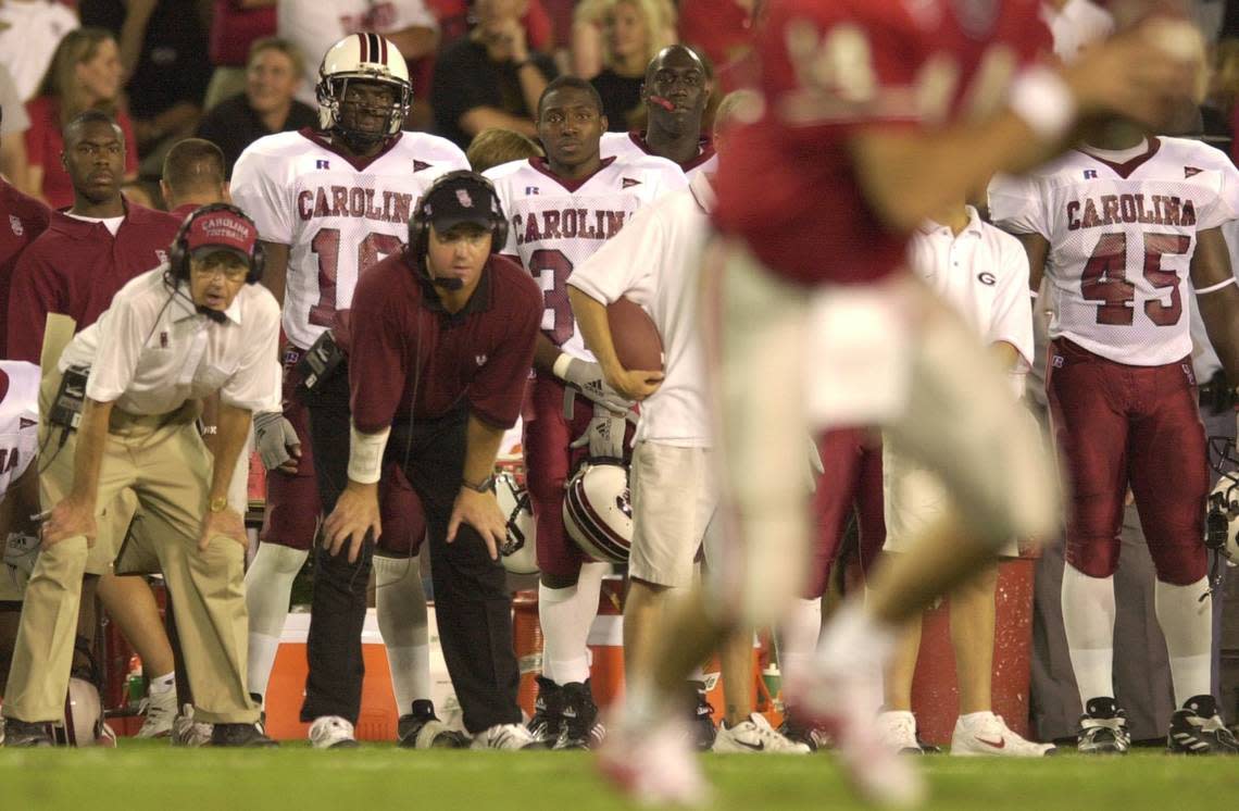 From Sept. 8, 2001: South Carolina head coach Lou Holtz, left, and son Skip Holtz watch the Georgia Bulldogs offense at Sanford Stadium in Athens.