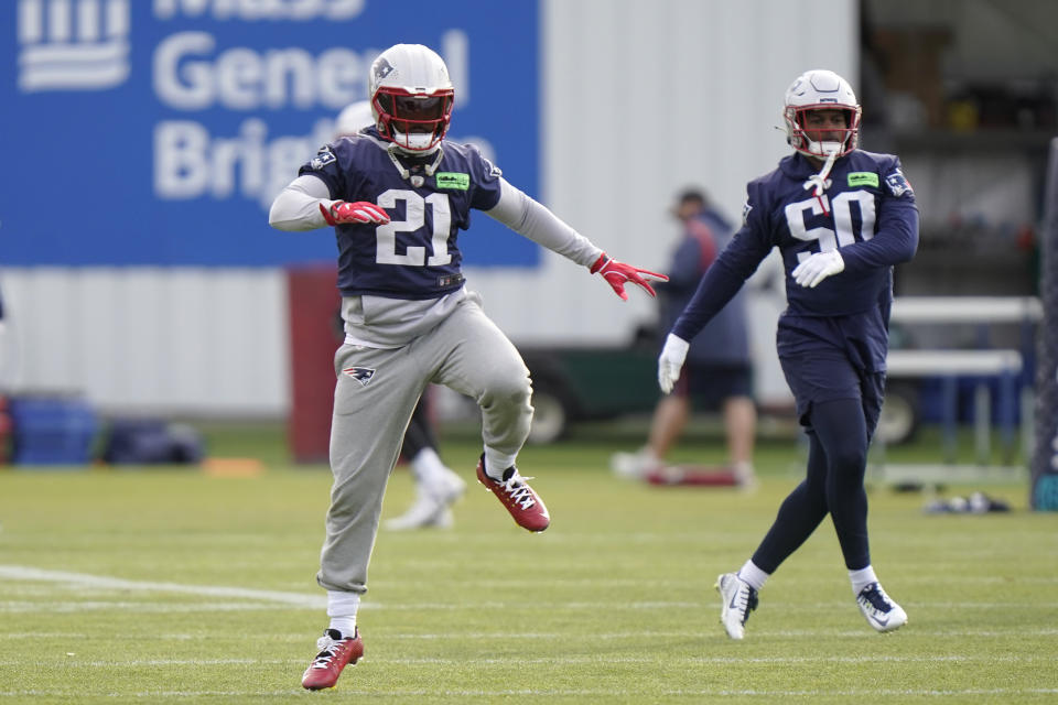 New England Patriots safety Adrian Phillips (21) and linebacker Raekwon McMillan (50) warm up during an NFL football practice, Tuesday, Dec. 6 2022, in Foxborough, Mass. (AP Photo/Steven Senne)