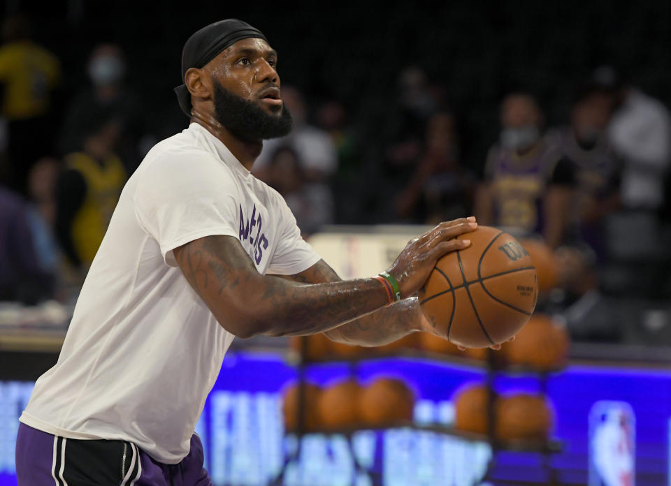 Los Angeles Lakers forward LeBron James (6) warms up before playing the Phoenix Suns in a preseason NBA basketball game in Los Angeles, Sunday, Oct. 10, 2021. (AP Photo/John McCoy)