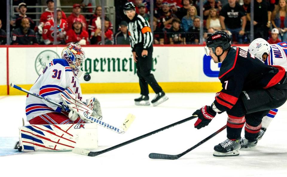 New York Rangers goaltender Igor Shesterkin (31) stops a scoring attempt by Carolina Hurricanes defenseman Dmitry Orlov (7) in the first period of Game 3 in the second round of the 2024 Stanley Cup playoffs on Thursday, May 9, 2024 at PNC Arena, in Raleigh N.C.