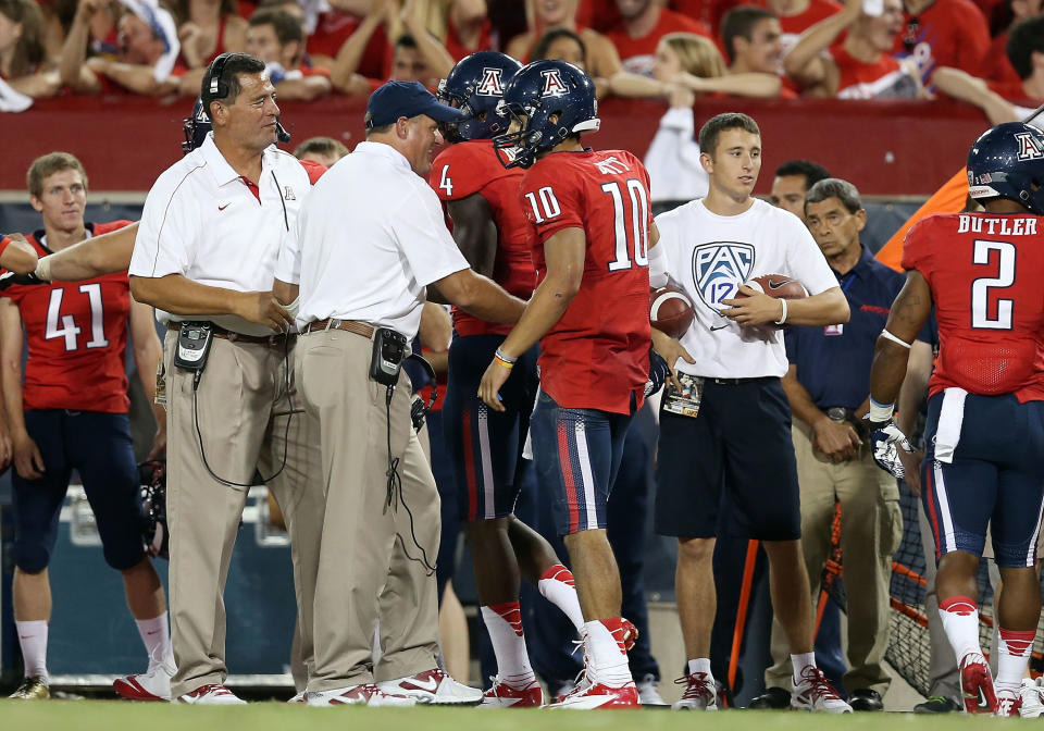 Matt Scott and Rich Rodriguez chat on the sideline during an Arizona football game in September 2012. (Getty Images)