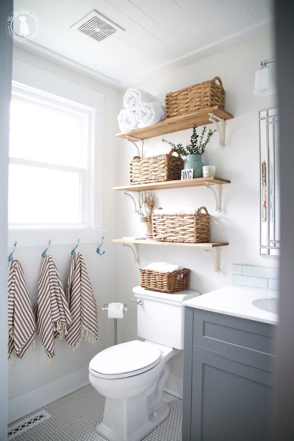 bathroom storage ideas, baskets on wooden shelves over the toilet