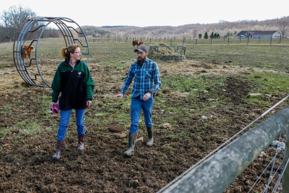 Nic Talbott walks through the pasture on his grandmother's farm in Lisbon, Ohio, with his mother, Tracy Carlton.