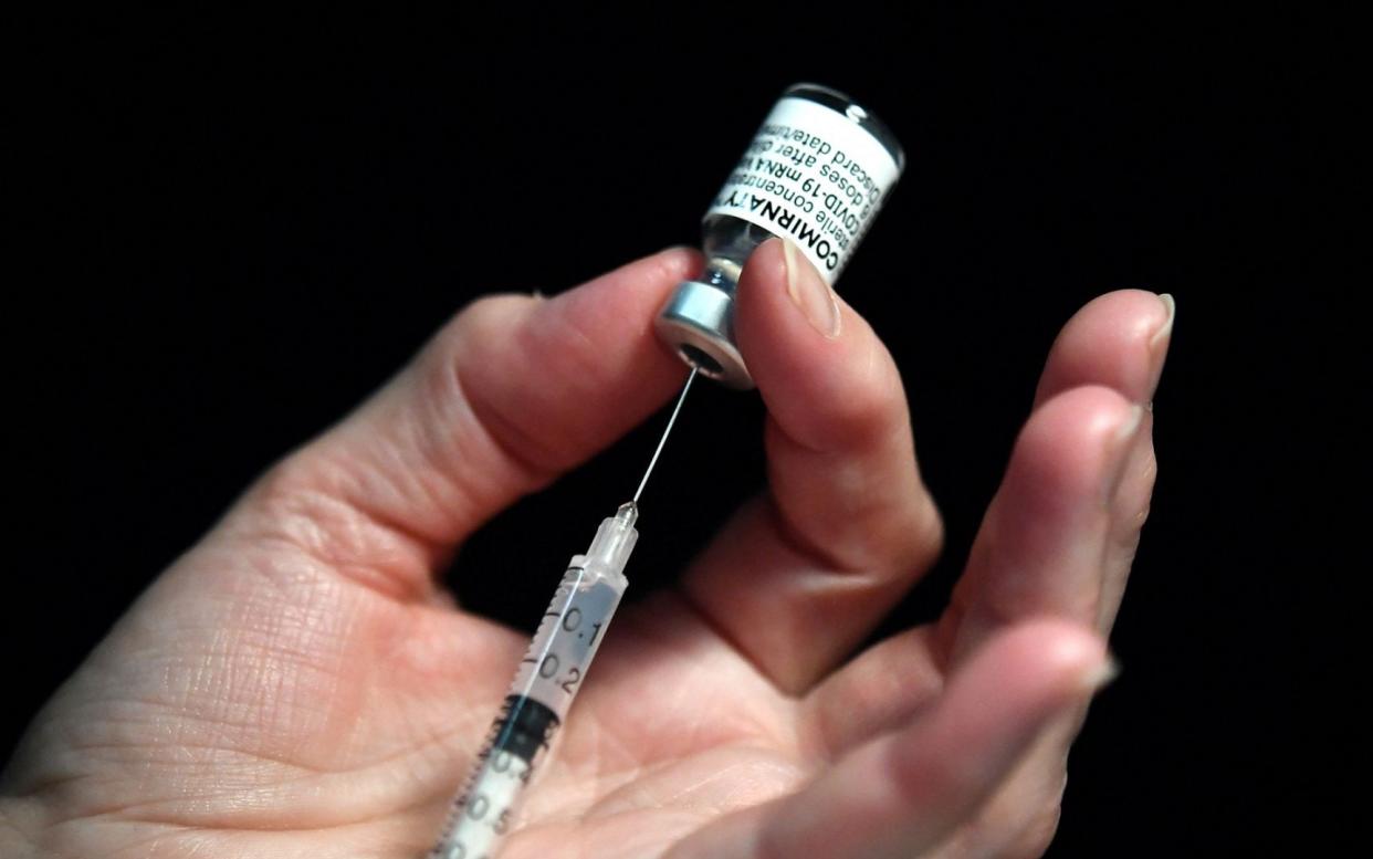 A nurse prepares a syringe of the Pfizer-BioNtech Covid-19 vaccine - FRED TANNEAU/AFP