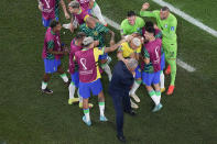 Brazil's Richarlison celebrates scoring his side's third goal with Brazil's head coach Tite during the World Cup round of 16 soccer match between Brazil and South Korea, at the Education City Stadium in Al Rayyan, Qatar, Monday, Dec. 5, 2022. (AP Photo/Pavel Golovkin)