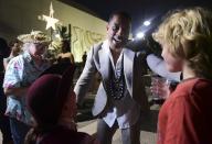 Leslie Odom Jr., the actor that plays the role of Aaron Burr greets people at the entrance plaza of the Santurce Fine Arts Center moments before the premiere of the award-winning Broadway musical, Hamilton, starring its creator, New York native of Puerto Rican descent Lin-Manuel Miranda, in San Juan, Puerto Rico, Friday Jan. 11, 2019. The musical is set to run for two weeks and will raise money for local arts programs. (AP Photo/Carlos Giusti)