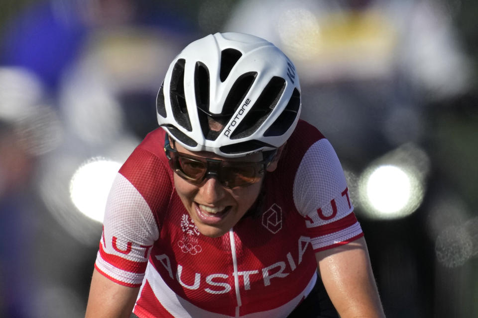 Anna Kiesenhofer of Austria, rides solo on her way to the gold medal in the women's cycling road race at the 2020 Summer Olympics, Sunday, July 25, 2021, in Oyama, Japan. (AP Photo/Christophe Ena)