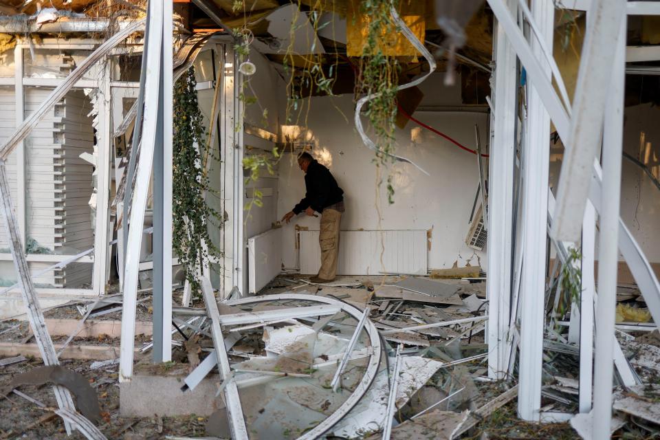 A man removes debris in a gallery damaged by a Russian missile strike in a park (REUTERS)