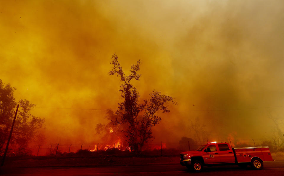 Thick smoke billows along Foothill Boulevard as the Creek Fire burns heavy brush in Los Angeles' Sylmar neighborhood on Dec. 5, 2017.