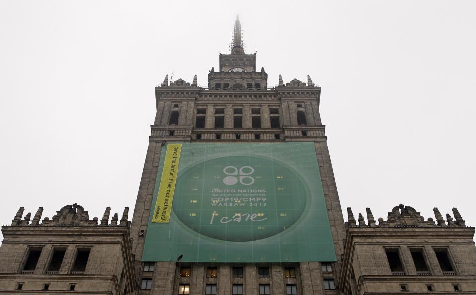 Greenpeace activists fix a banner on the Palace of Culture and Science demanding protection of the Arctic region and the release of the so-called "Arctic 30" group during the 19th conference of the United Nations Framework Convention on Climate Change (COP19) in Warsaw November 21, 2013. Three of the 30 people arrested, during a Greenpeace protest walked free on bail on Thursday, defiant that the action against Arctic oil drilling was justified and that the response by the authorities was not. REUTERS/Kacper Pempel (POLAND - Tags: POLITICS ENVIRONMENT BUSINESS)