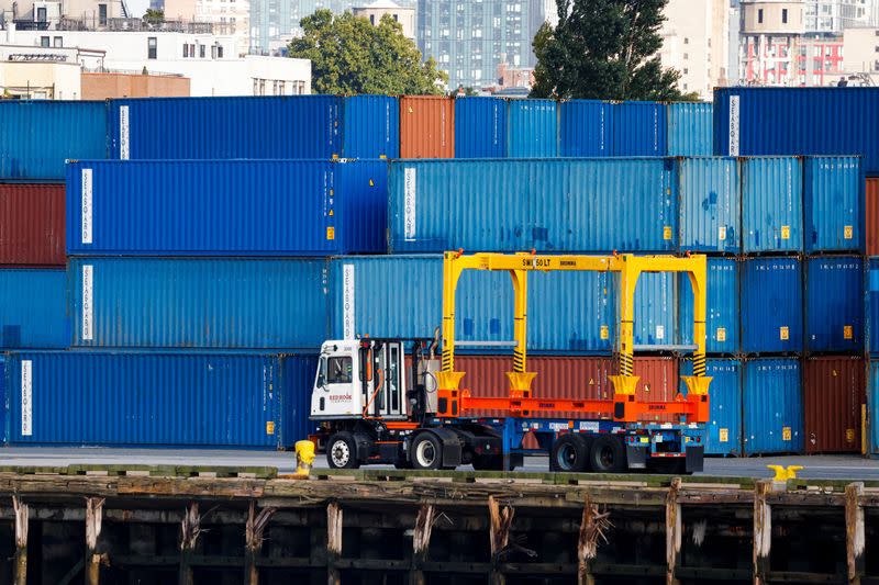 Shipping containers are stacked on a pier at the Red Hook Terminal in Brooklyn, New York