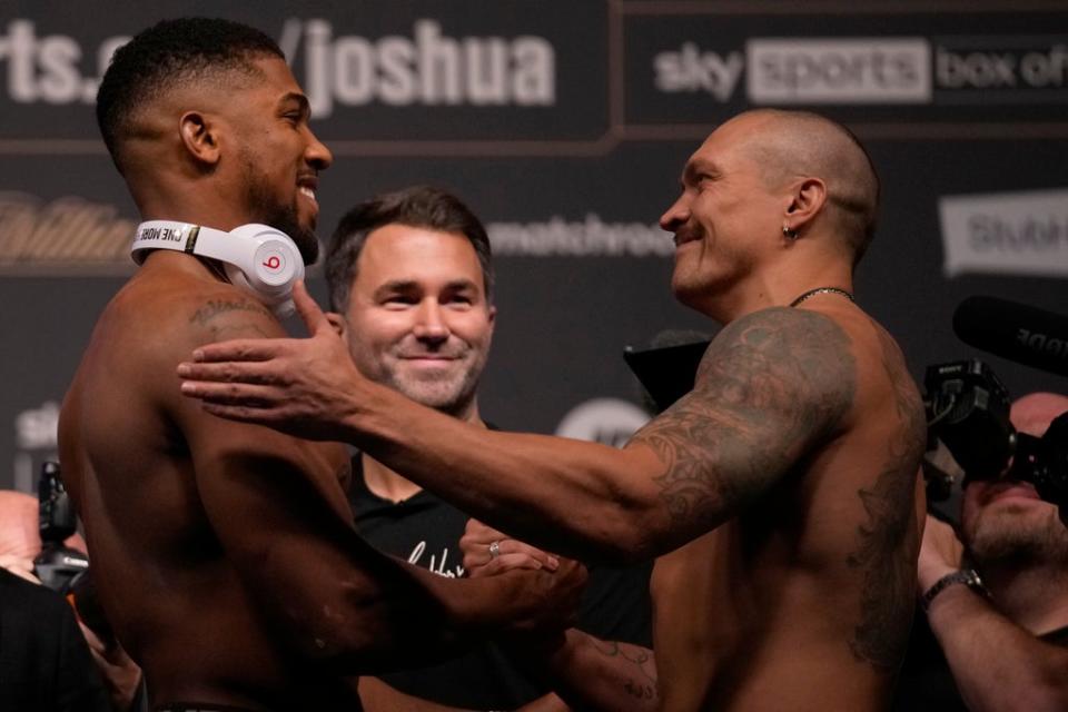 Joshua and Usyk exchange pleasantries at the weigh-in (AP)