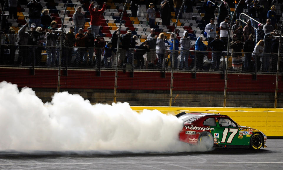 CHARLOTTE, NC - OCTOBER 15: Matt Kenseth, driver of the #17 Fluidmaster Ford, celebrates with a burnout after winning the NASCAR Sprint Cup Series Bank of America 500 at Charlotte Motor Speedway on October 15, 2011 in Charlotte, North Carolina. (Photo by Jared C. Tilton/Getty Images for NASCAR)