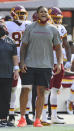 Washington Football Team defensive end Chase Young, right, watches from the sidelines during the second half of an NFL football game against the Cleveland Browns, Sunday, Sept. 27, 2020, in Cleveland. (AP Photo/David Richard)