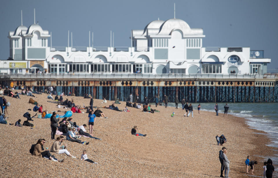 People enjoy the warm weather on Southsea beach in Hampshire. Picture date: Sunday April 4, 2021.