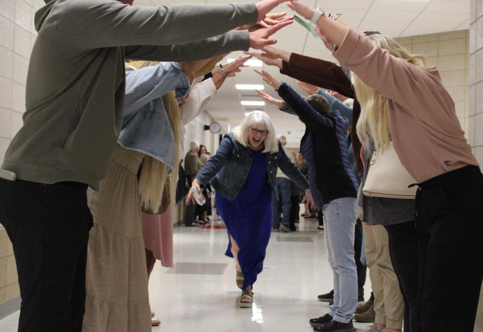 Susan Thies runs through a tunnel her colleagues made in the hallway after she was named the 36th Annual Dr. John W. Harris Teacher of the Year for the Sioux Falls School District at Ben Reifel Middle School on Feb. 26, 2024.