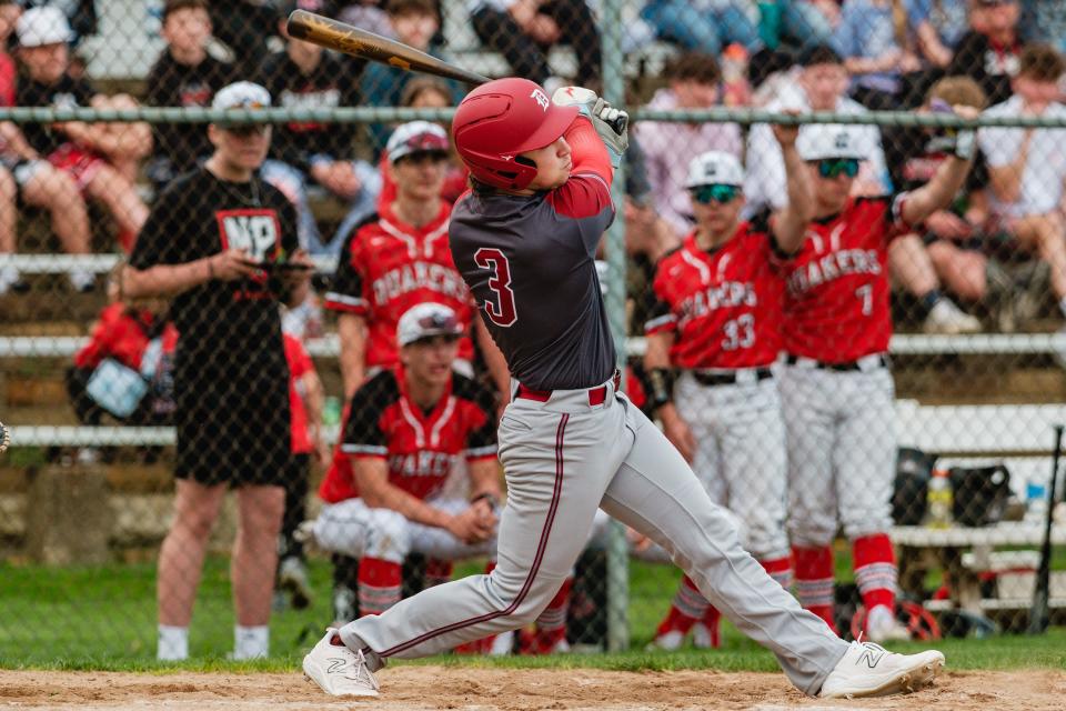 Dover's Ethan Kellicker follows through on a swing during an annual rival game against New Philadelphia, Friday, April 19 at Tuscora Park.