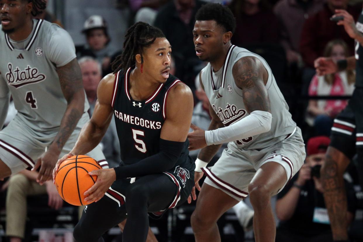 Mar 9, 2024; Starkville, Mississippi, USA; South Carolina Gamecocks guard Meechie Johnson (5) handles the ball as Mississippi State Bulldogs guard Dashawn Davis (10) defends during the second half at Humphrey Coliseum. Mandatory Credit: Petre Thomas-USA TODAY Sports