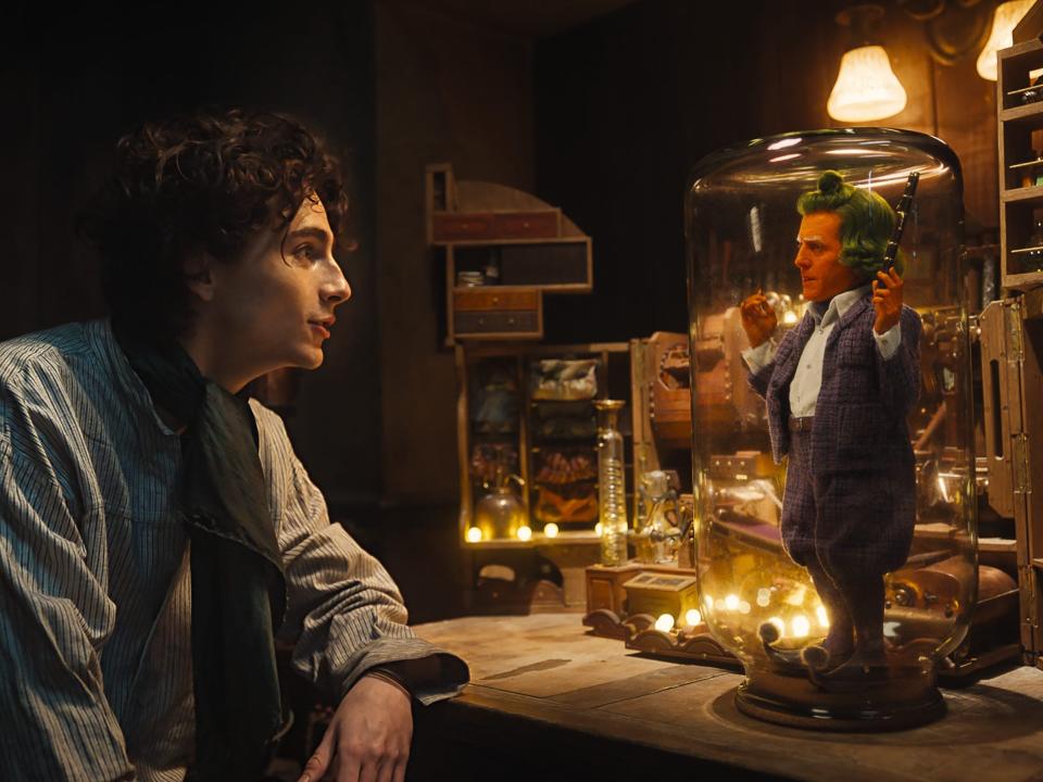Timothée Chalamet as Willy Wonka and Hugh Grant as an Oompa Loompa in "Wonka."