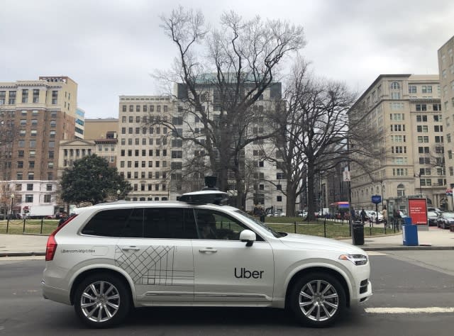 An Uber car equipped with cameras and sensors drives the streets of Washington, DC, on January 24, 2020. - Uber Advanced Technologies Group (ATG) announced it would begin data collection for self-driving vehicles on Washington, DC, roads beginning January 24. ATG self-driving vehicles - operated by two human drivers, better known as Mission Specialists - will collect road data to support the development of Ubers self-driving vehicle technology. (Photo by Eric BARADAT / AFP) (Photo by ERIC BARADAT/AFP via Getty Images)