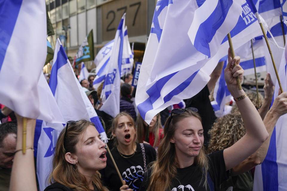 Protesters wave flags and chant slogans near the site of a planned meeting between United States President Joe Biden and Israeli Prime Minister Benjamin Netanyahu in New York, Wednesday, Sept. 20, 2023. (AP Photo/Seth Wenig)