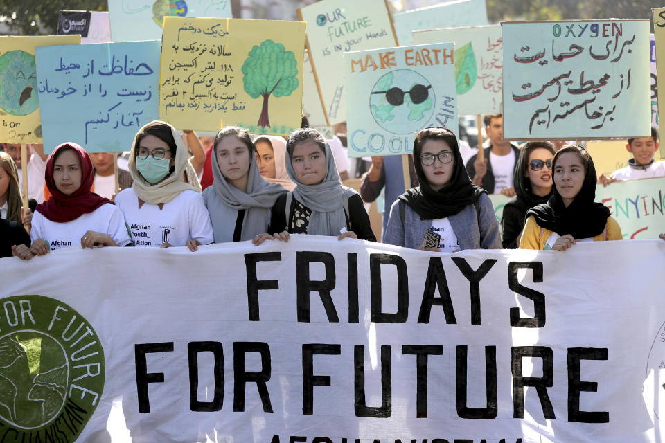 Young people attend a Climate Strike rally, in Kabul, Afghanistan, Friday, Sept. 20, 2019. In the Afghan capital, where people are dying every day in horrific bomb attacks, a young generation, worried that if war doesn't kill them climate change will, took part in the global climate strike. (AP Photo/Ebrahim Noroozi)