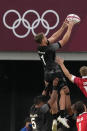 New Zealand's Scott Curry is lifted by teammates to catch the ball on a lineout, in their men's rugby sevens quarterfinal match against Canada at the 2020 Summer Olympics, Tuesday, July 27, 2021 in Tokyo, Japan. (AP Photo/Shuji Kajiyama)