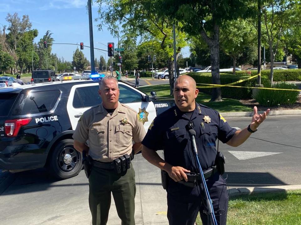 Fresno Police Chief Paco Balderrama, right, and Fresno Sheriff’s Office Lt. Robert Woodrum on Friday morning, May 20, 2022, give an update on an overnight standoff with a suspect at a Save Mart grocery store in Fresno, California.