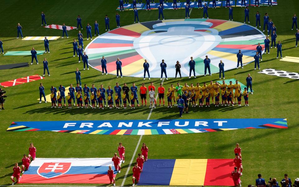 The players line up for the anthems.