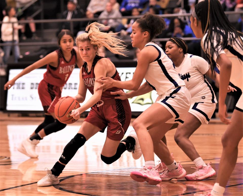 Ballinger's Addison Martin drives around Wichita Falls City View's Chyree Pennington in the first half.