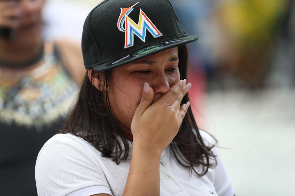 <p>A person reacts after watching the hearse carrying Miami Marlins pitcher Jose Fernandez pass in front of the Marlins baseball stadium on September 28, 2016 in Miami, Florida. Mr. Fernandez was killed in a weekend boat crash in Miami Beach along with two friends. (Photo by Joe Raedle/Getty Images) </p>