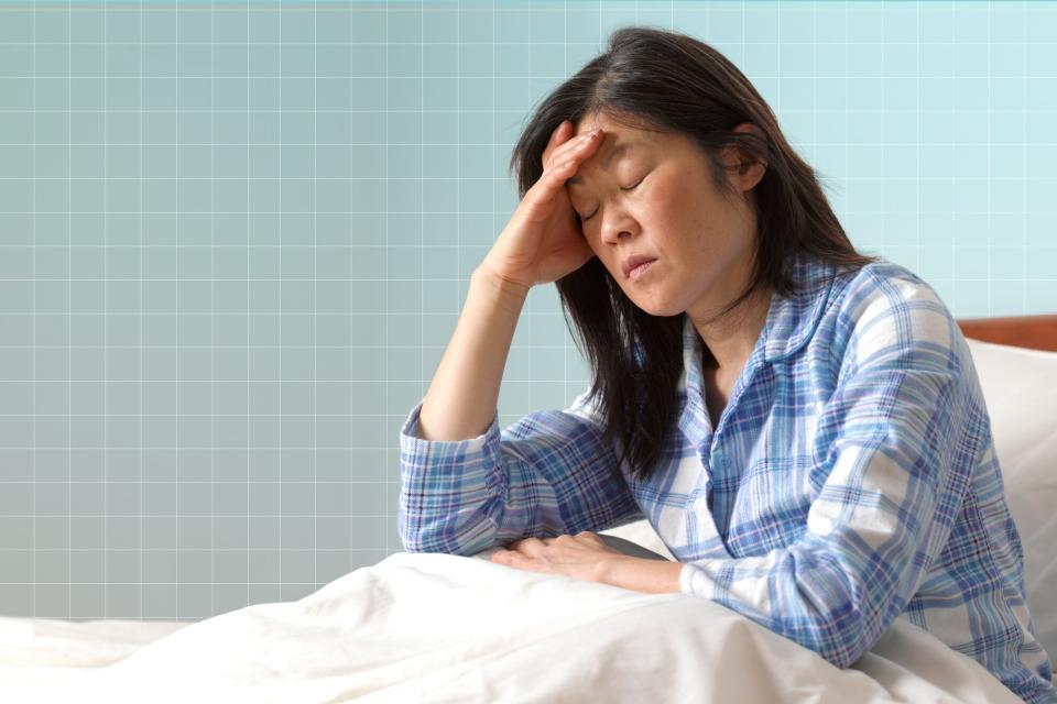 a photo of a woman looking tired after waking up in bed