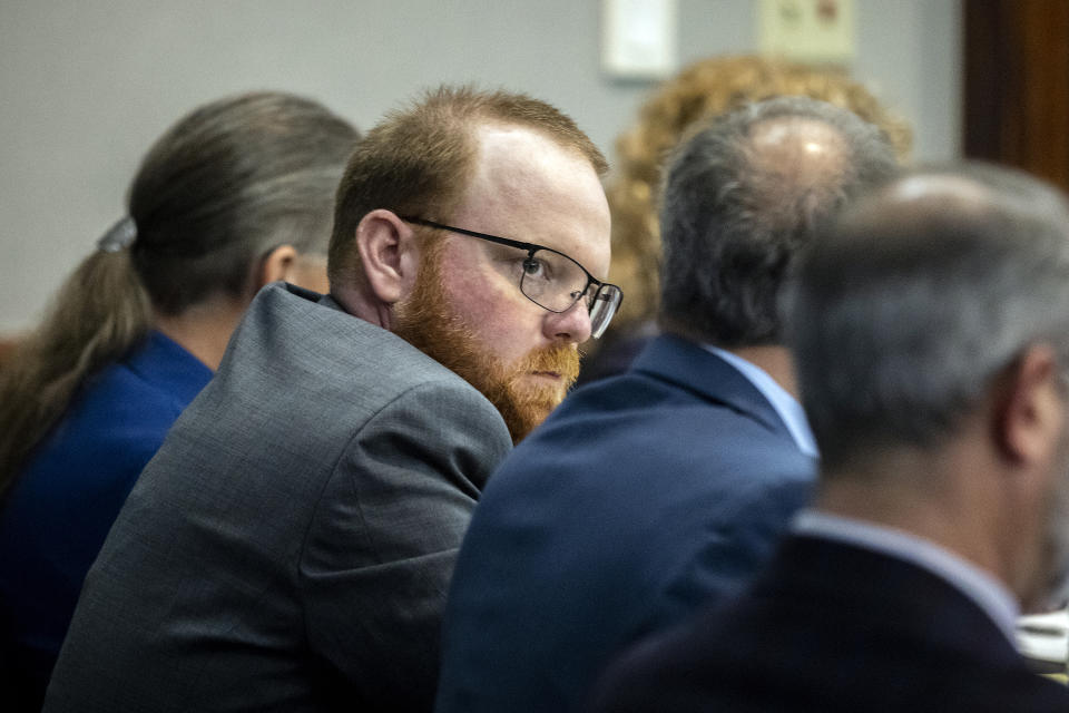 Travis McMichael sits with his attorneys before the start of closing arguments to the jury during the trial of he, and his father Greg McMichael, and William "Roddie" Bryan, at the Glynn County Courthouse, Monday, Nov. 22, 2021, in Brunswick, Ga. The three men charged with the February 2020 slaying of 25-year-old Ahmaud Arbery. (AP Photo/Stephen B. Morton, Pool)