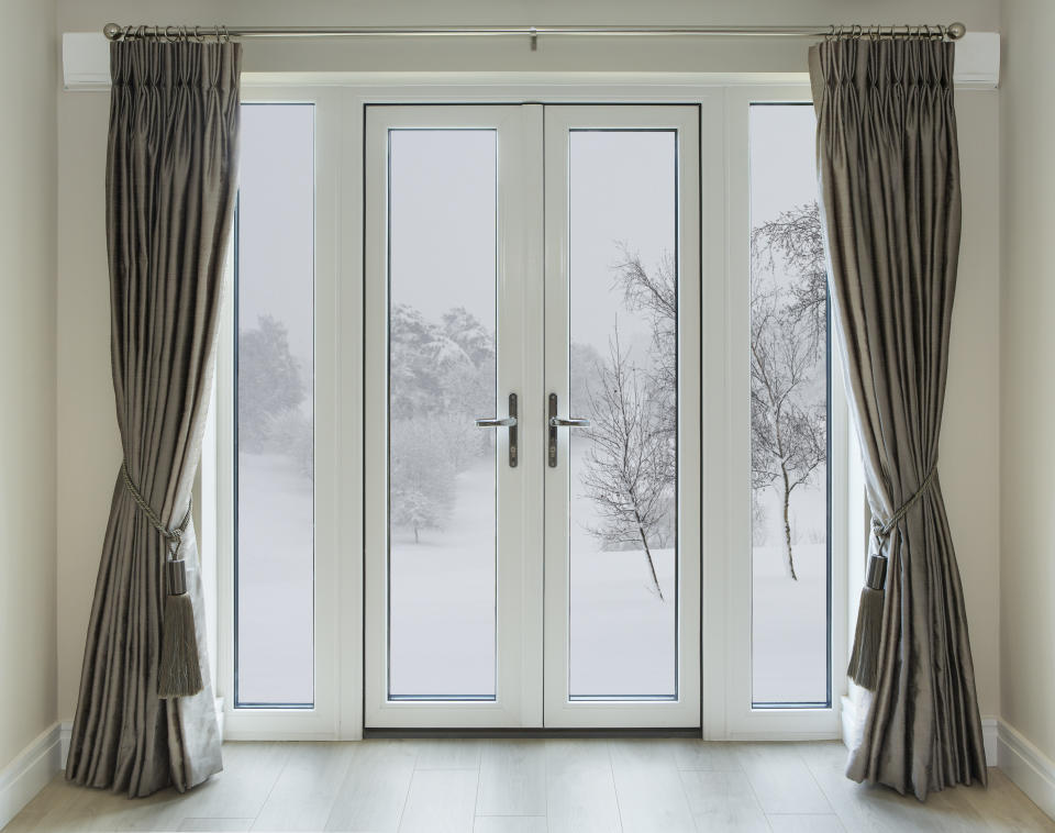 Curtains in front of windows and doors stop cold air coming in and warm air going out. Photo: Getty