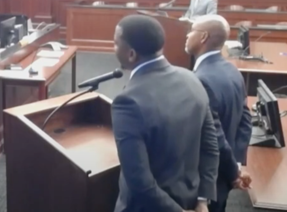 Former Jacksonville sheriff's officer Christopher Barr, left, and attorney Kevin Cobbin react to Judge Tatiana Salvador's explanation of his Monday sentence of 60 days in jail for providing restricted police intel to unauthorized individuals.